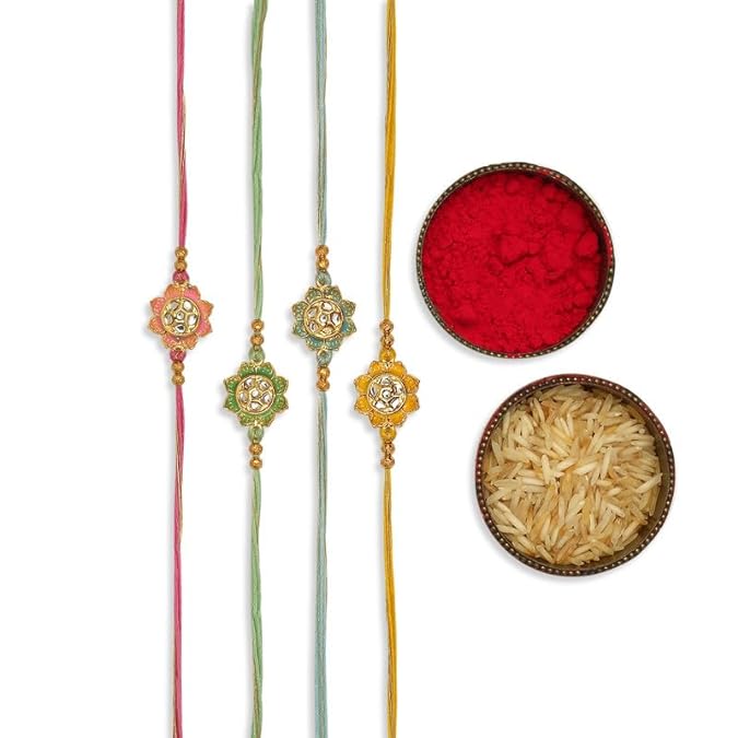 Three rakhi's with gold and pink beads, symbolizing love and protection. Red powder with bowl of rice, representing auspiciousness.