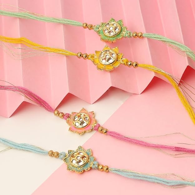 Four rakhi's with gold and pink beads, symbolizing love and protection during the festival of Raksha Bandhan.