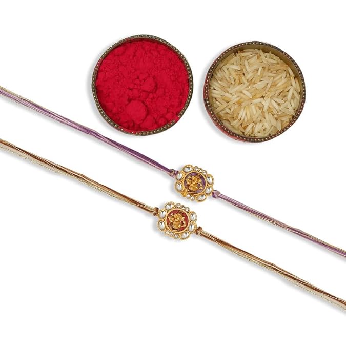 Two beautiful rakhi with gold and purple beads, accompanied by vermilion and a bowl of rice, symbolizing Raksha Bandhan festivities.