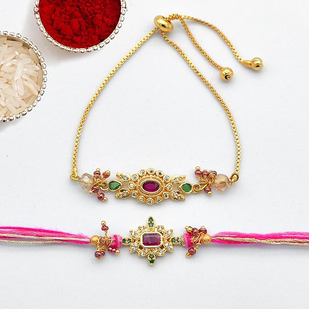 Two gold Rakhi adorned with delicate pink and yellow flowers, adding a touch of femininity to any ensemble.