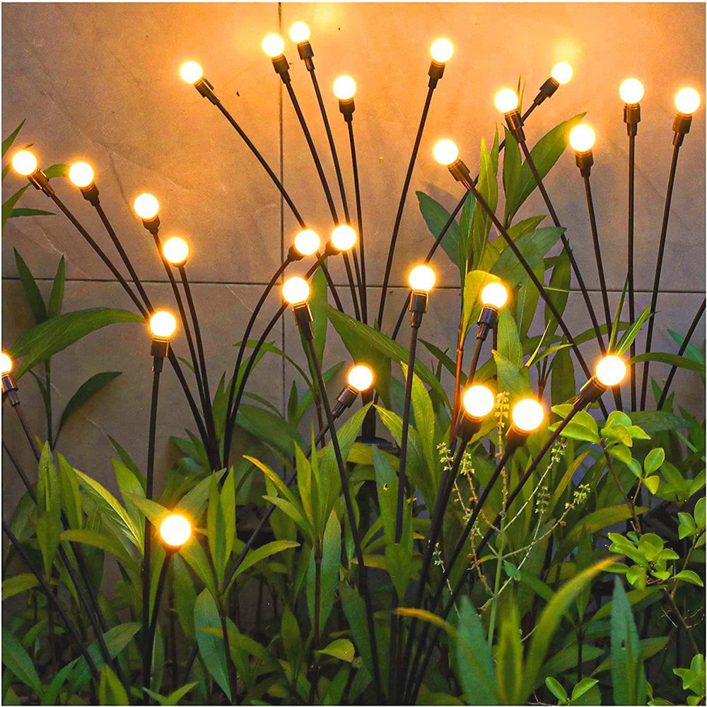  Garden lights casting a warm glow on a serene outdoor setting.