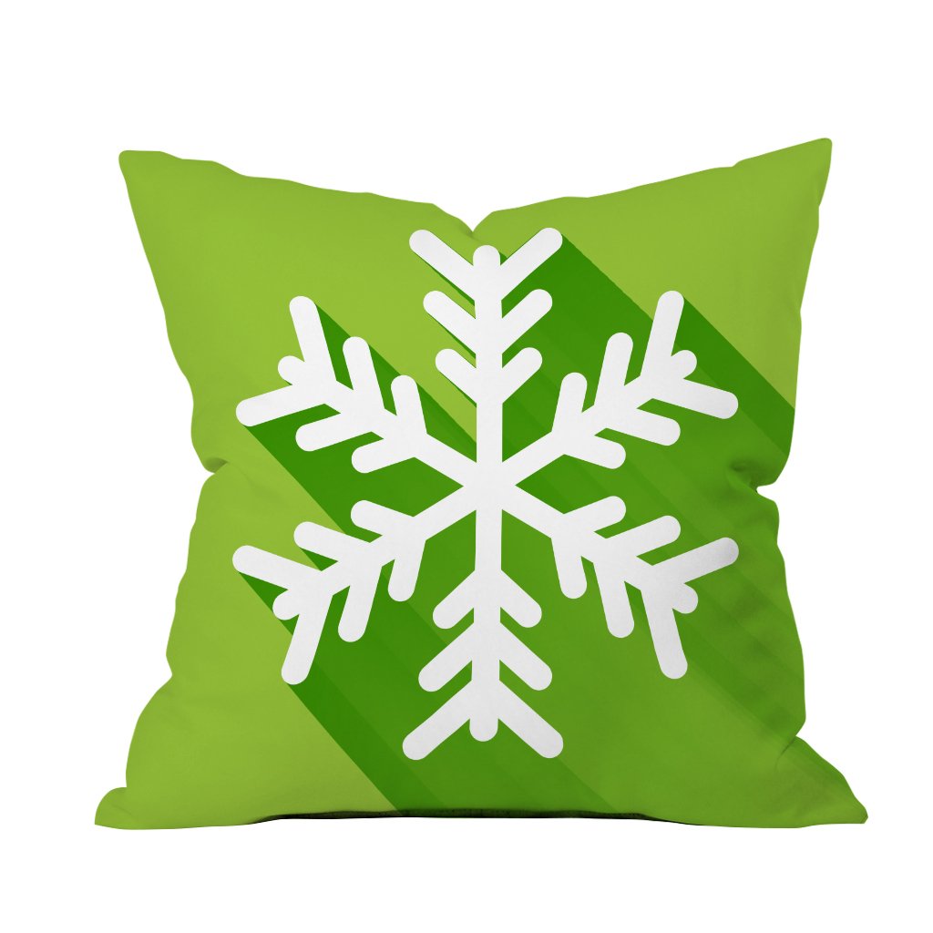 A green and white snowflake pillow rests against a clean white background, adding a touch of winter charm to the decor.

