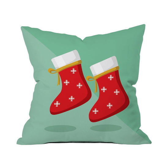 A cozy pillow adorned with a pair of vibrant red socks resting on top.

