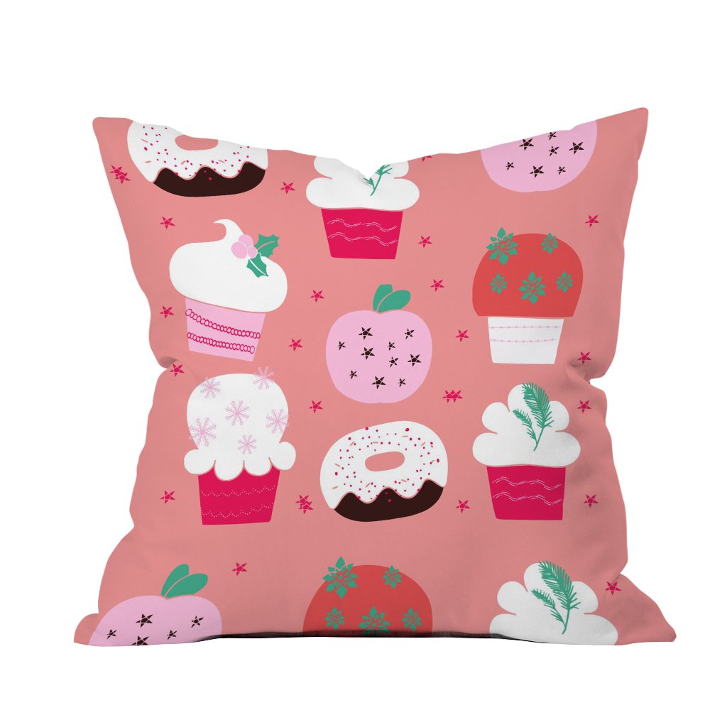 A cozy pink pillow adorned with colorful cupcakes and donuts, perfect for adding a sweet touch to any space.

