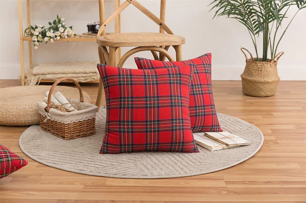 Two stylish red plaid pillows on a fluffy white rug, enhancing the comfort and charm of the room.