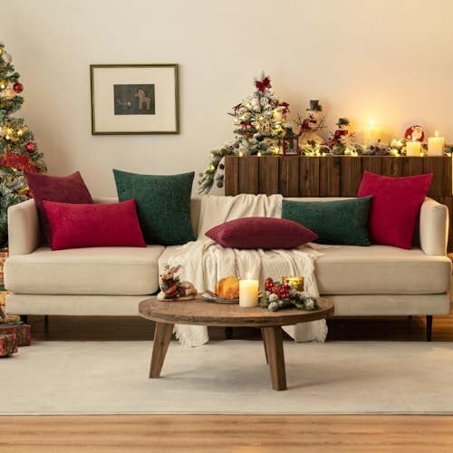 Two cheerful red pillows sit on a couch, adding warmth next to a lovely Christmas tree.