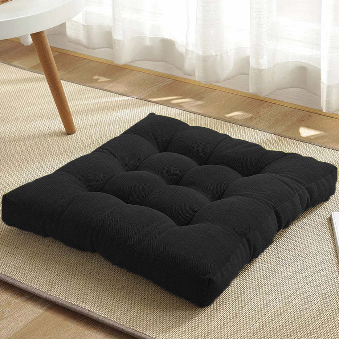 Stylish black cushion on rug