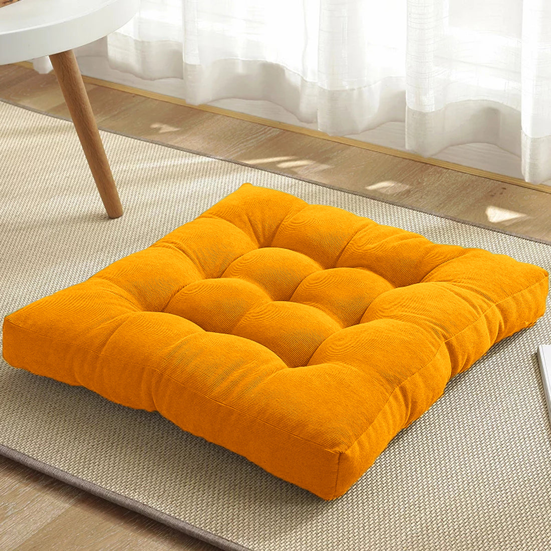 Yellow cushion on the floor.