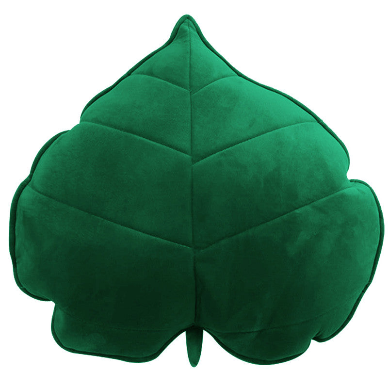 A cozy  leaf-shaped cushion on a clean white background, perfect for adding a touch of nature to your home decor.