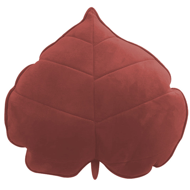 A cozy  leaf-shaped cushion on a clean white background, perfect for adding a touch of nature to your home decor.