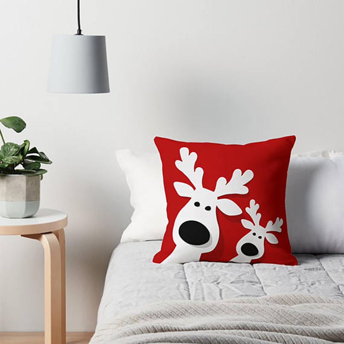 Decorative pillow featuring two reindeer.