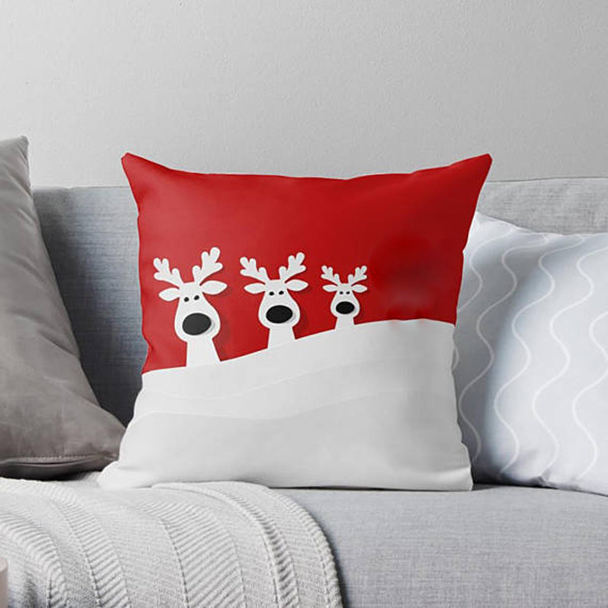 Adorable reindeers relaxing on a red and white pillow.