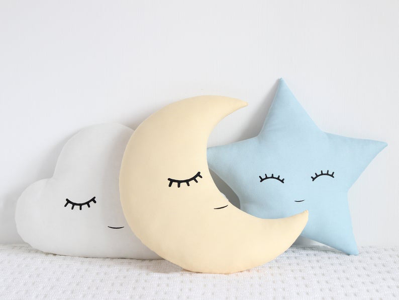 Pillows adorned with cloud, star, and moon patterns.