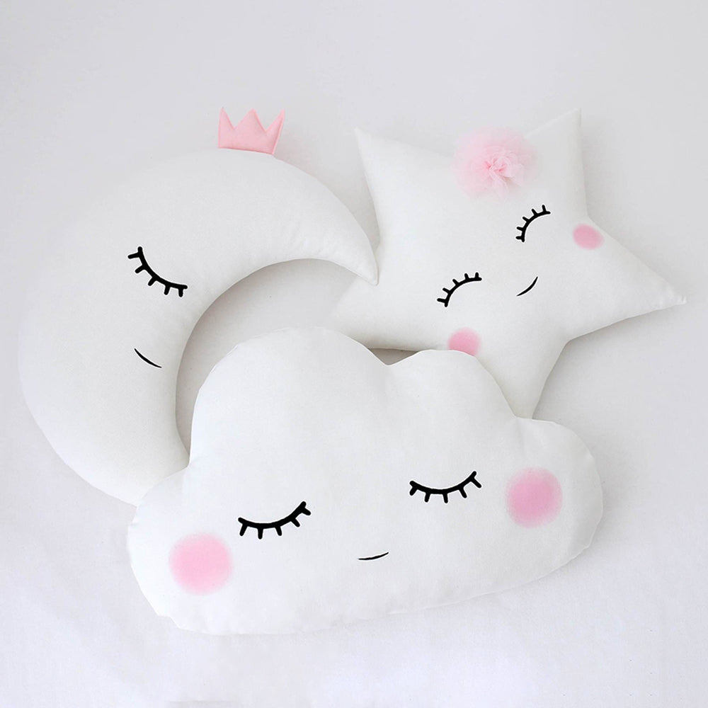 Three pillows featuring a cute cloud and moon face design, perfect for adding a playful element to home furnishings.