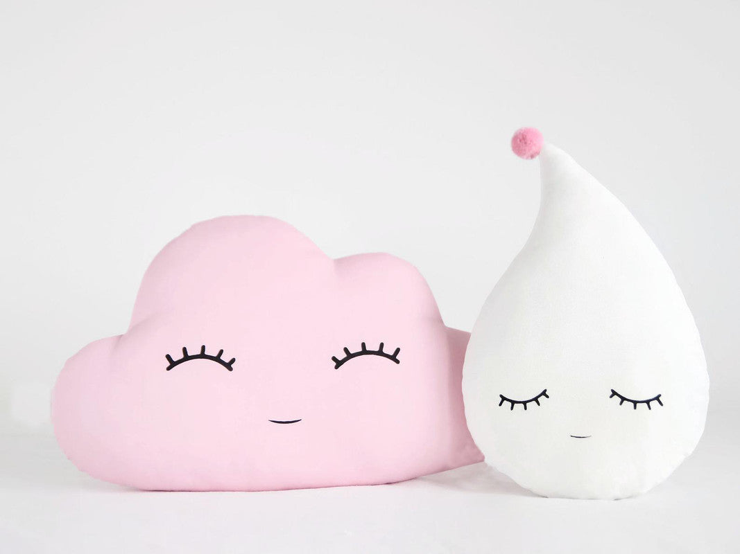 Two pink cloud pillows with eyes and eyelashes, perfect for adding a touch of cuteness to any room.