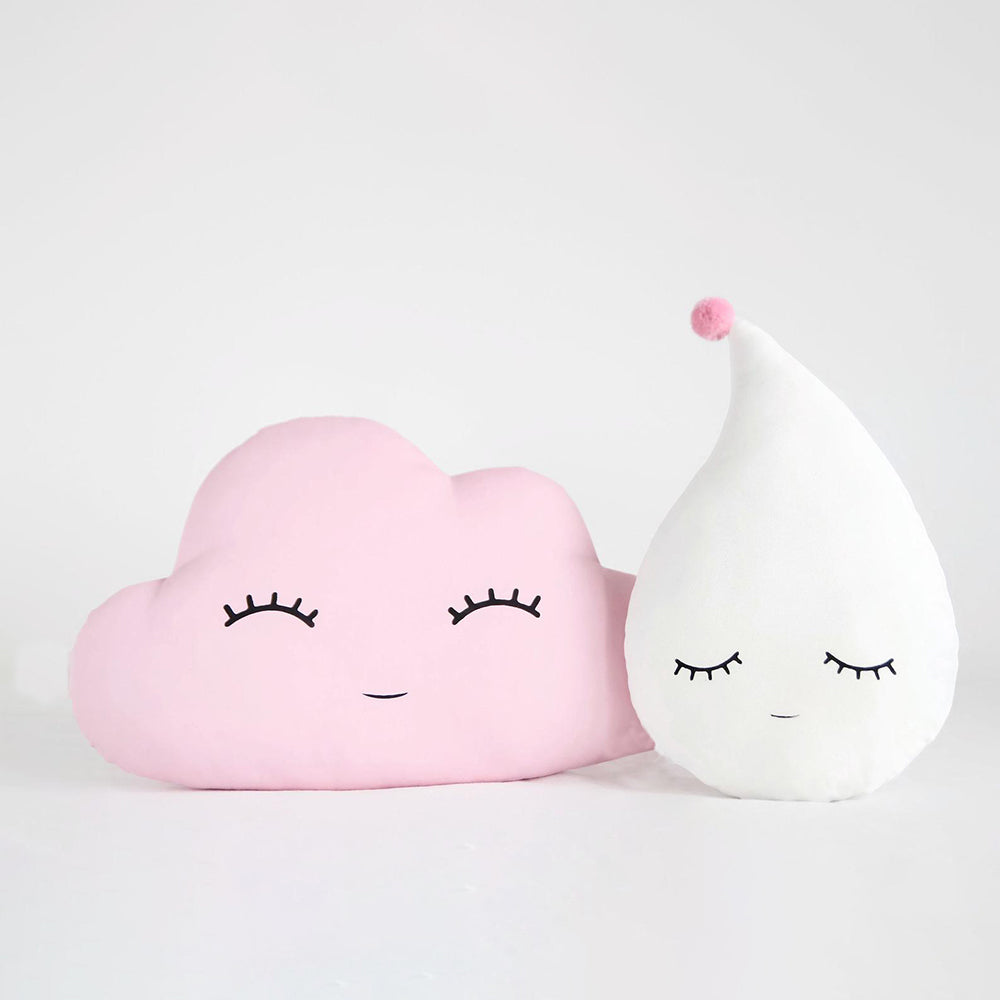 Two whimsical pillows with eyes rest beside a fluffy cloud, creating a playful and imaginative scene.

