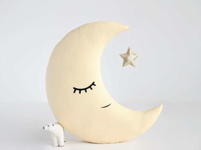 1. White bear-shaped pillow with crescent design.