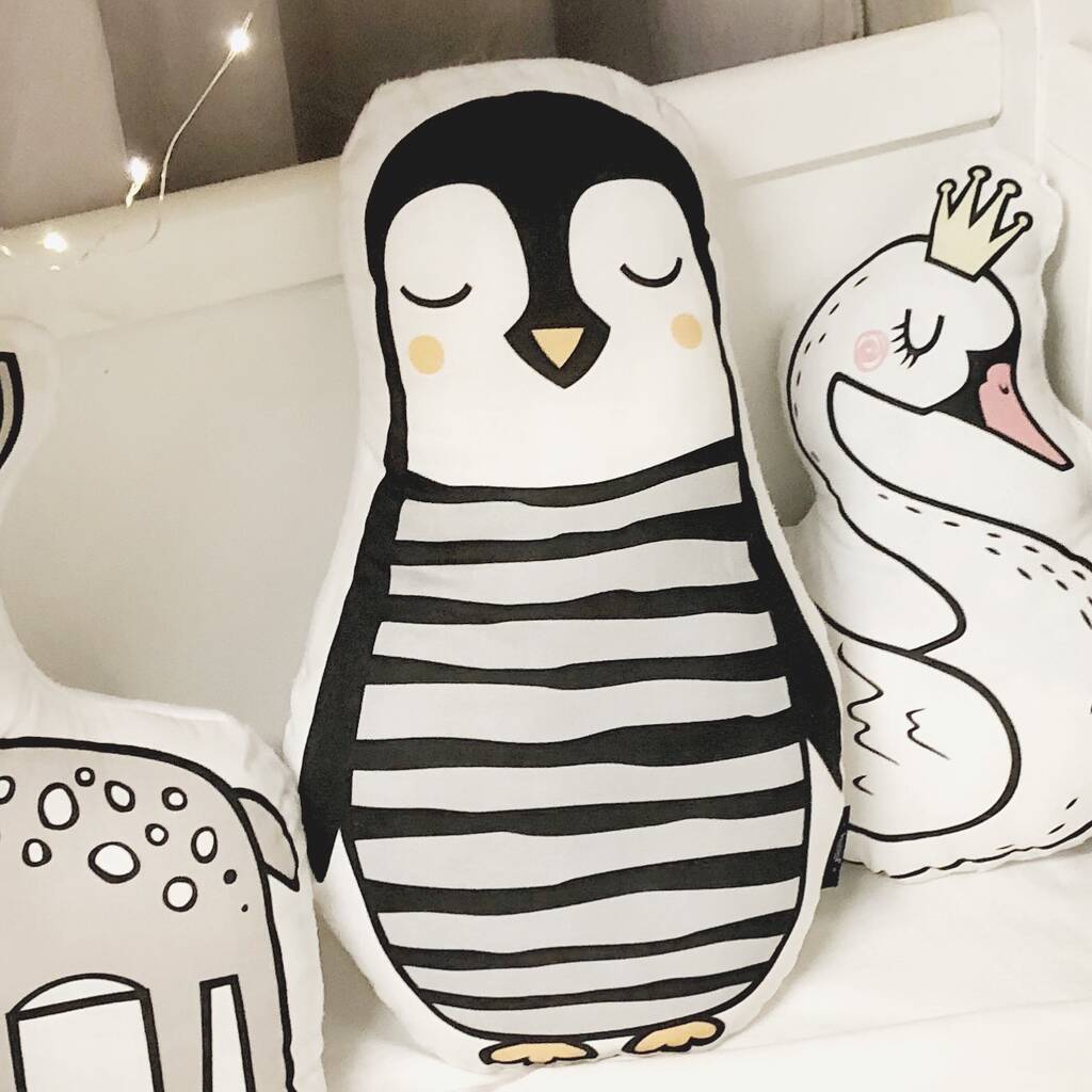 Adorable penguin pillow featuring black and white stripes.