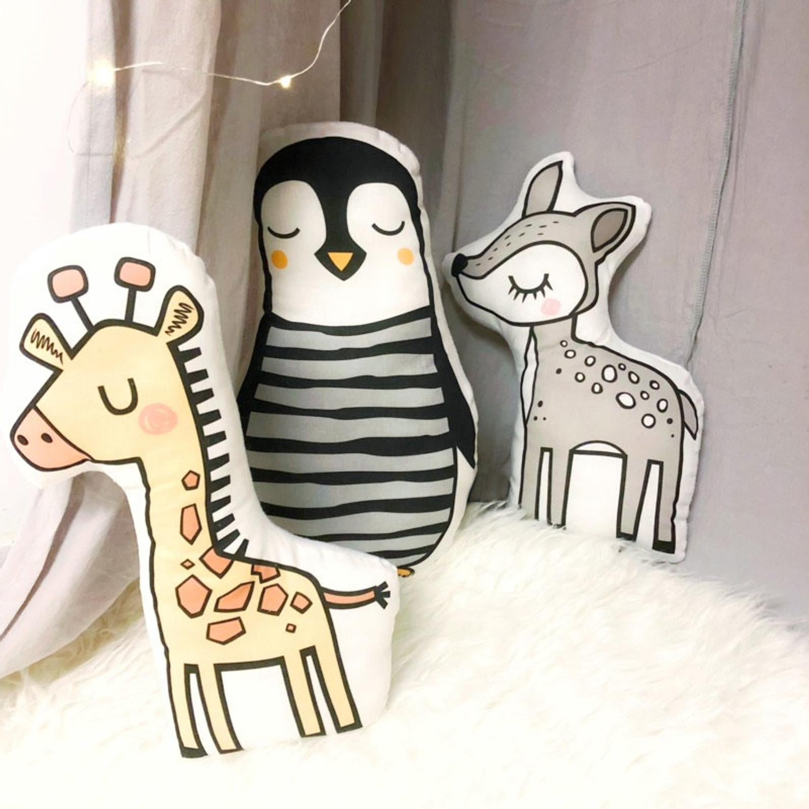 Penguin-shaped pillow with stylish black and white stripes.