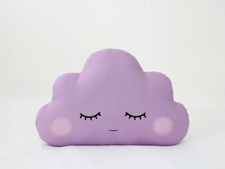 A cozy purple cloud pillow, peacefully resting with its eyes closed.