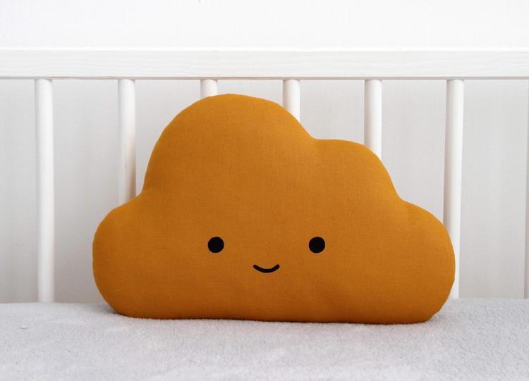 A cloud pillow with a smiling face on it, bringing comfort and joy to your sleep.