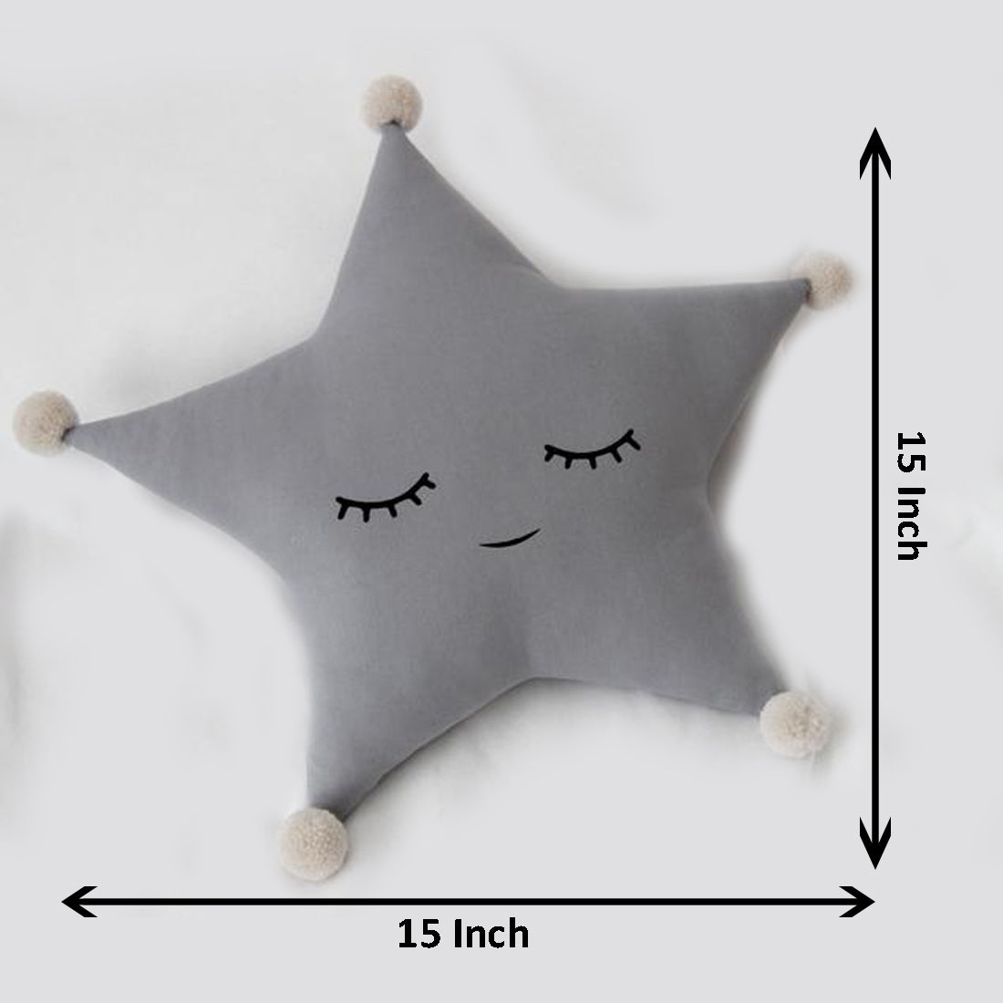 Cute grey star pillow with eyes and pom poms, perfect for adding a touch of whimsy to your home decor.