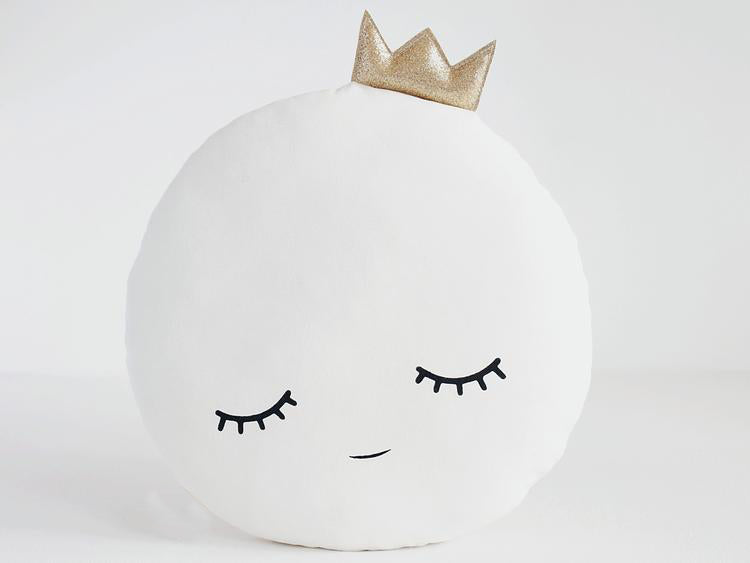 A regal pillow adorned with a crown, adding a touch of royalty and elegance to any space.