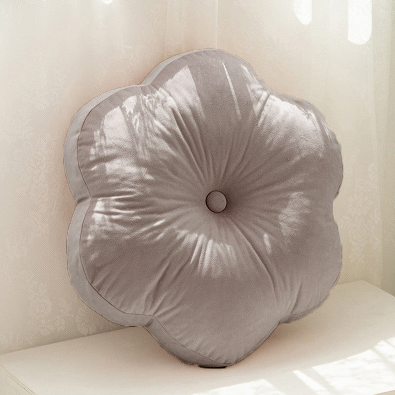  flower cushion on white table, adding a pop of color to your decor.