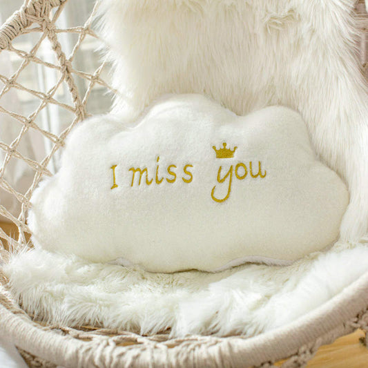  "A soft pillow with 'I miss you' embroidered on it, perfect for sending a heartfelt message to a loved one."