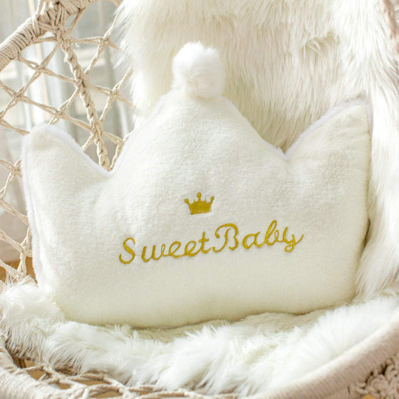 A white pillow with the words "Sweet Baby" embroidered on it, perfect for a cozy nursery or baby's room.