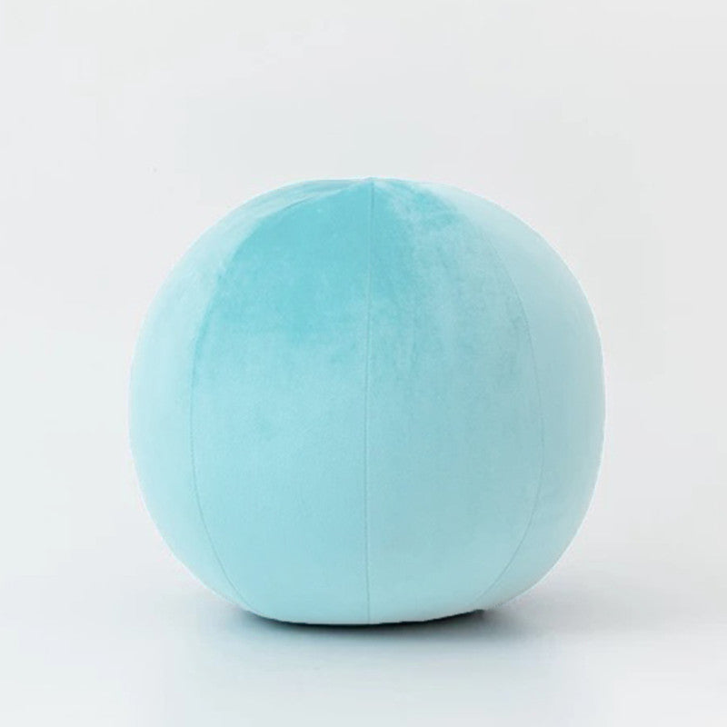 A blue ball-shaped pillow on a white background, adding a touch of softness and charm to any space.