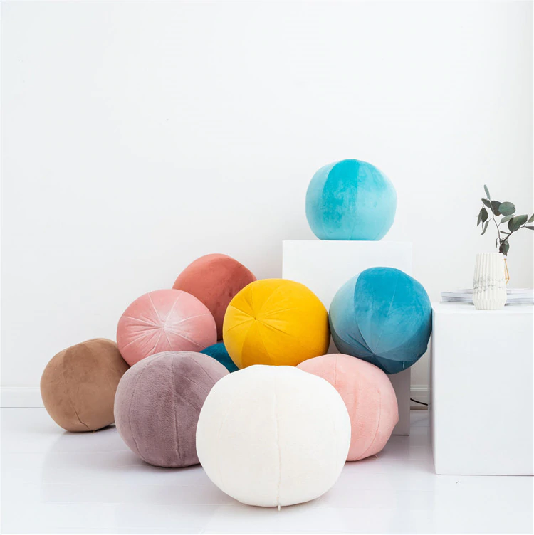 Colorful balls scattered on white floor.