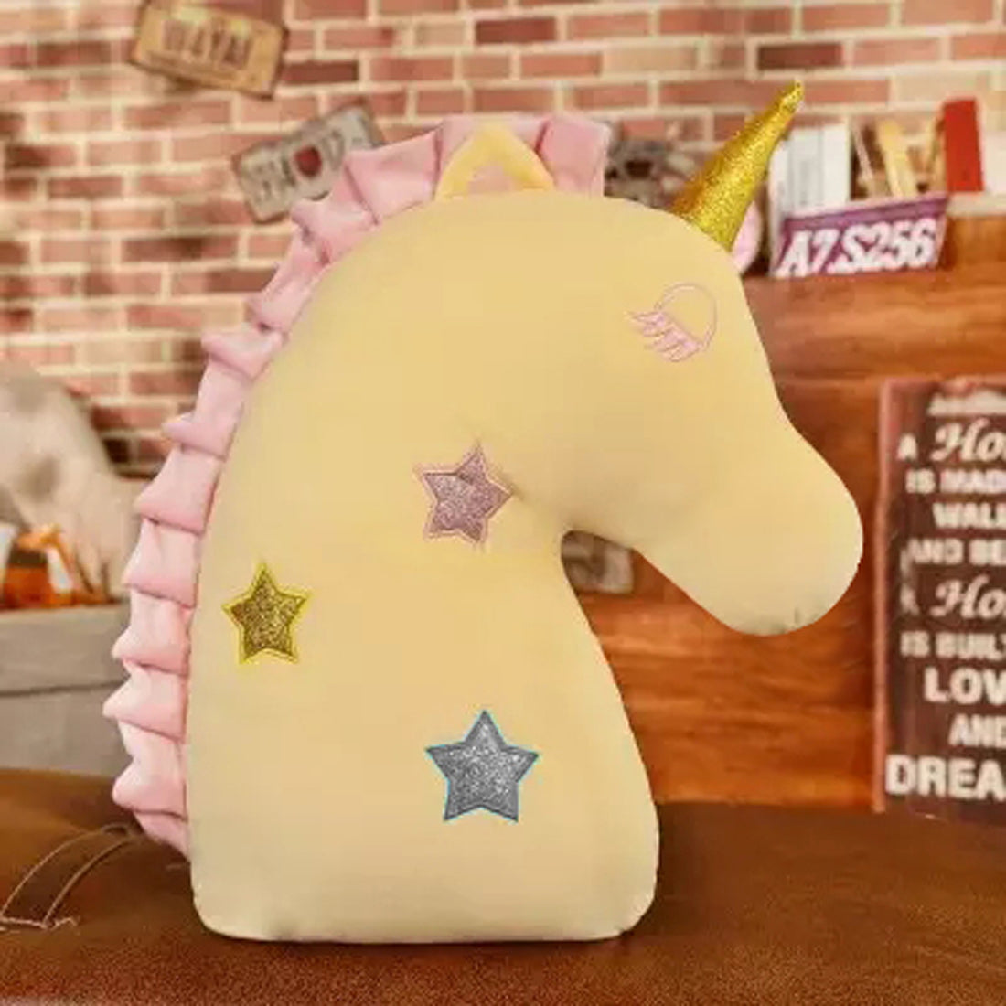  Decorative yellow  unicorn head pillow adorned with pink and gold stars, ideal for unicorn lovers of all ages.