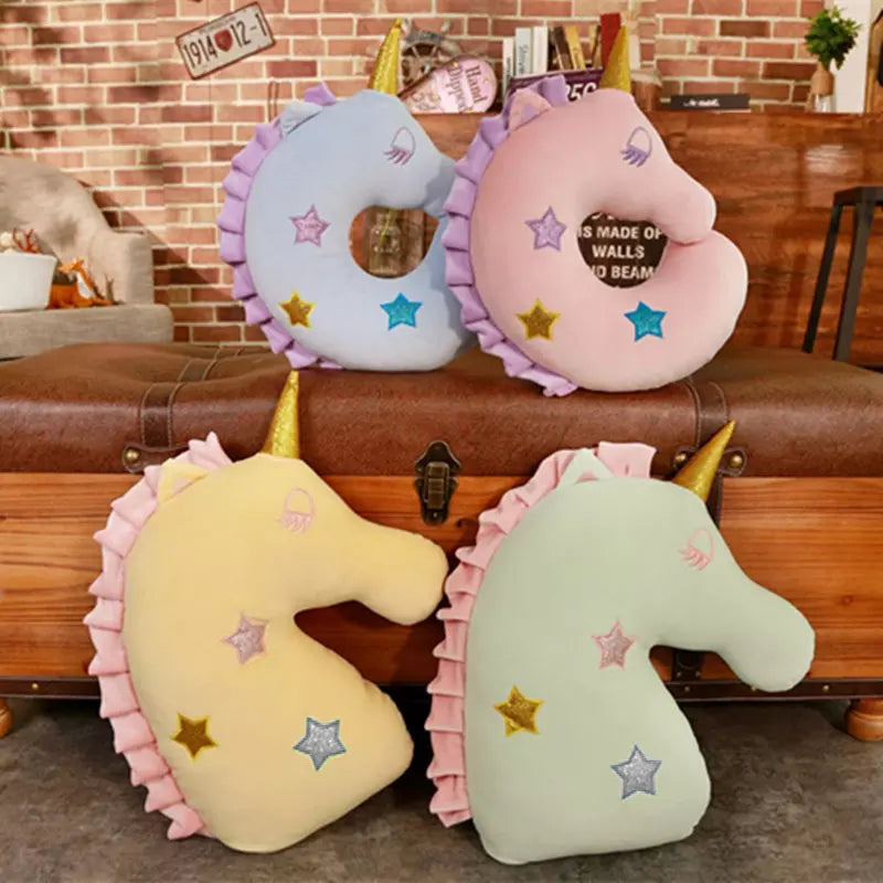 unicorn head pillow adorned with stars, a charming addition to any cozy space.