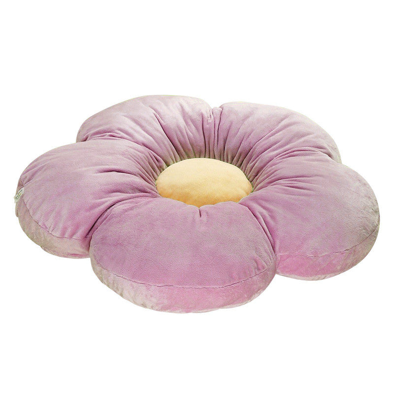 A large pink flower cushion with a yellow center, adding a touch of elegance and comfort to any space.