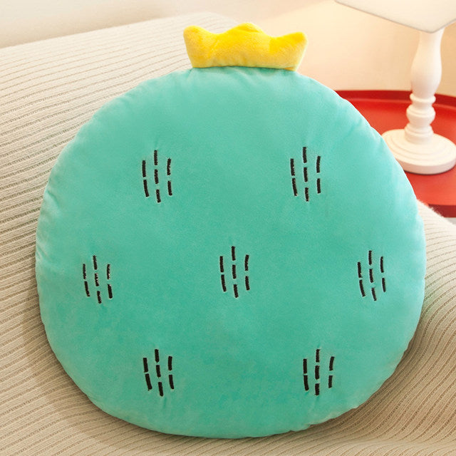 A pillow with a green fruit on it, adding a touch of freshness and vibrancy to your living space.