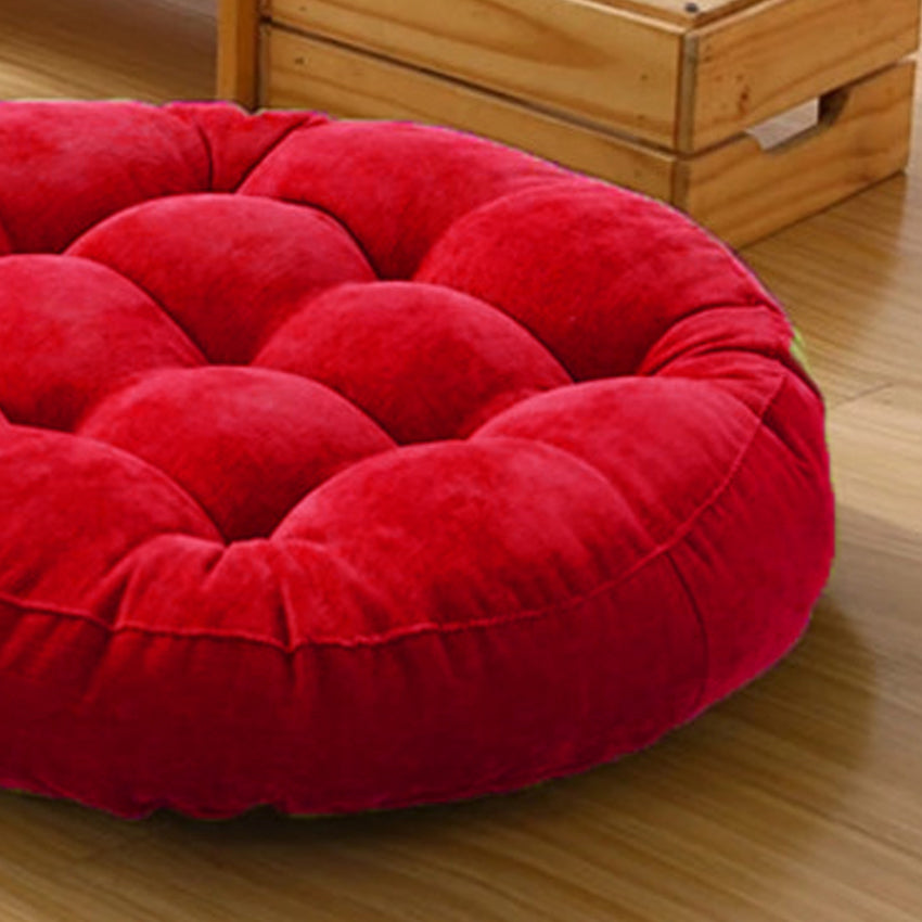 Red circular cushions on wood floor.