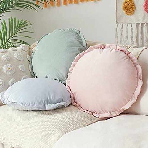 Four colorful round pillows arranged neatly on a bed.