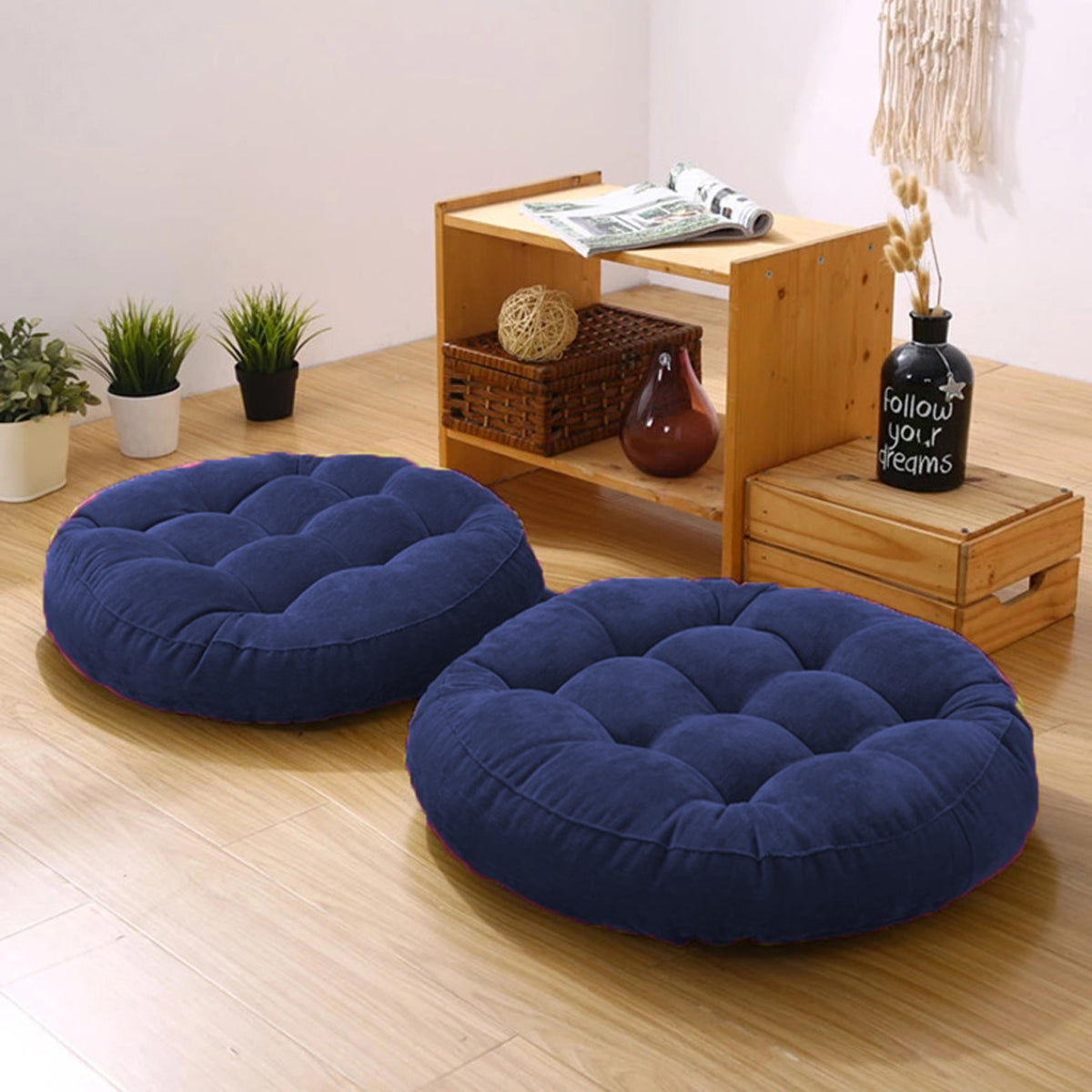  Two round cushions on a wooden floor in a cozy living room setting.