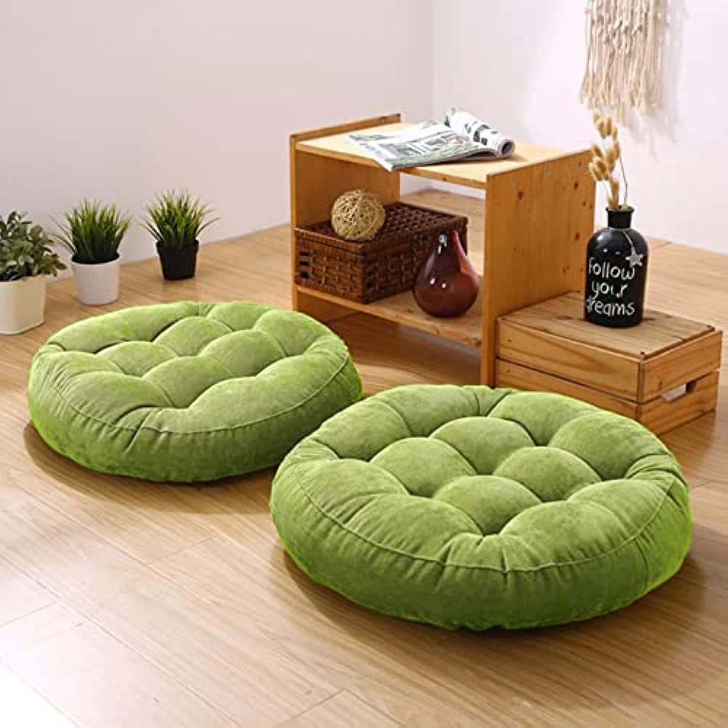 Wooden floor with two green cushions.