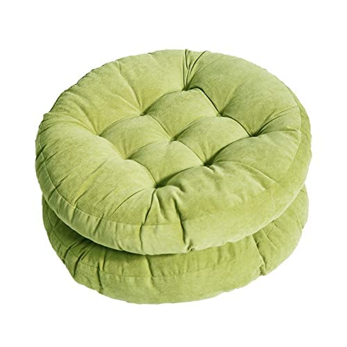 A vibrant green round cushion on a white surface.