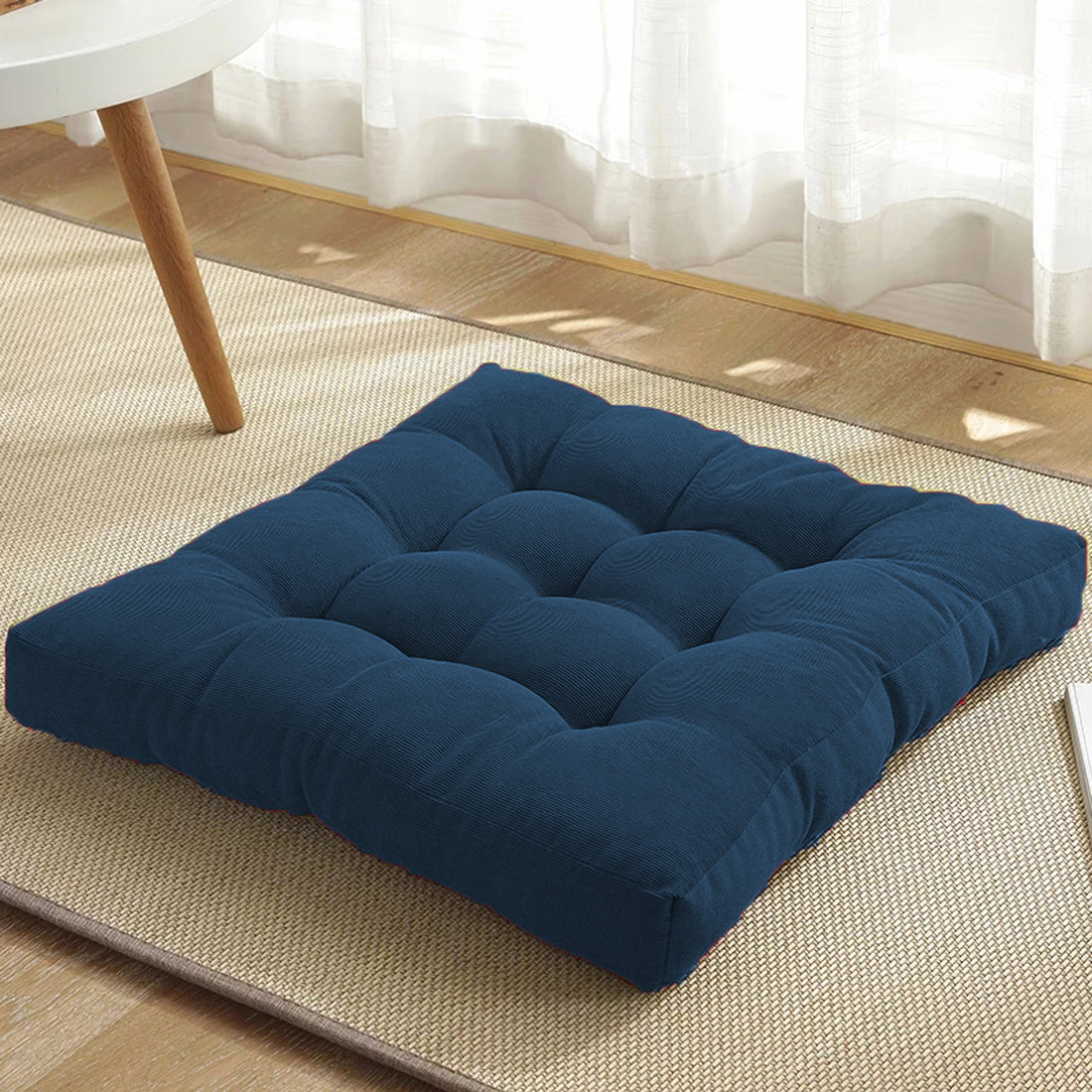 A cushion on a rug in blue.