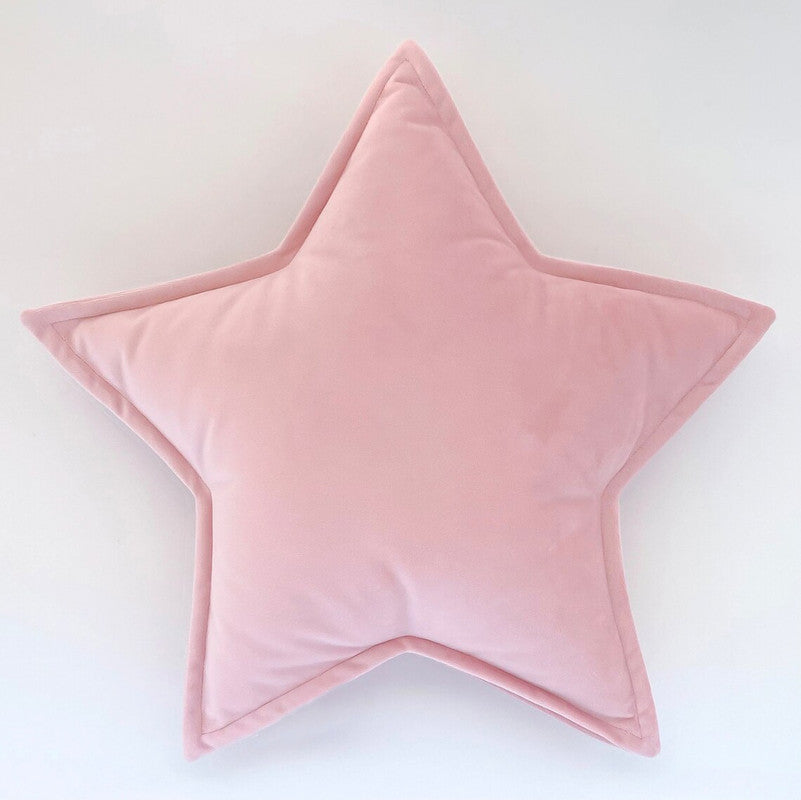 A cozy pink star pillow on a white background, perfect for adding a touch of whimsy to any room.