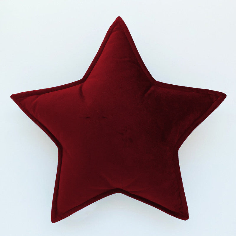 A cozy red velvet star pillow, perfect for adding a touch of luxury and comfort to any space.