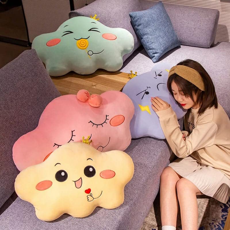 Pillow designed like a cloud with a cheerful expression and lollipop.