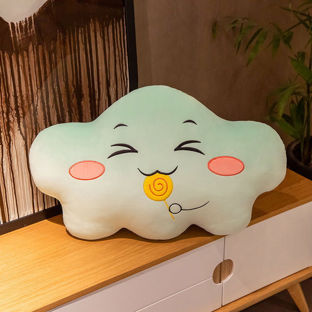 A pillow with a smiling cloud face and a colorful lollipop. A whimsical combination of comfort and sweetness.