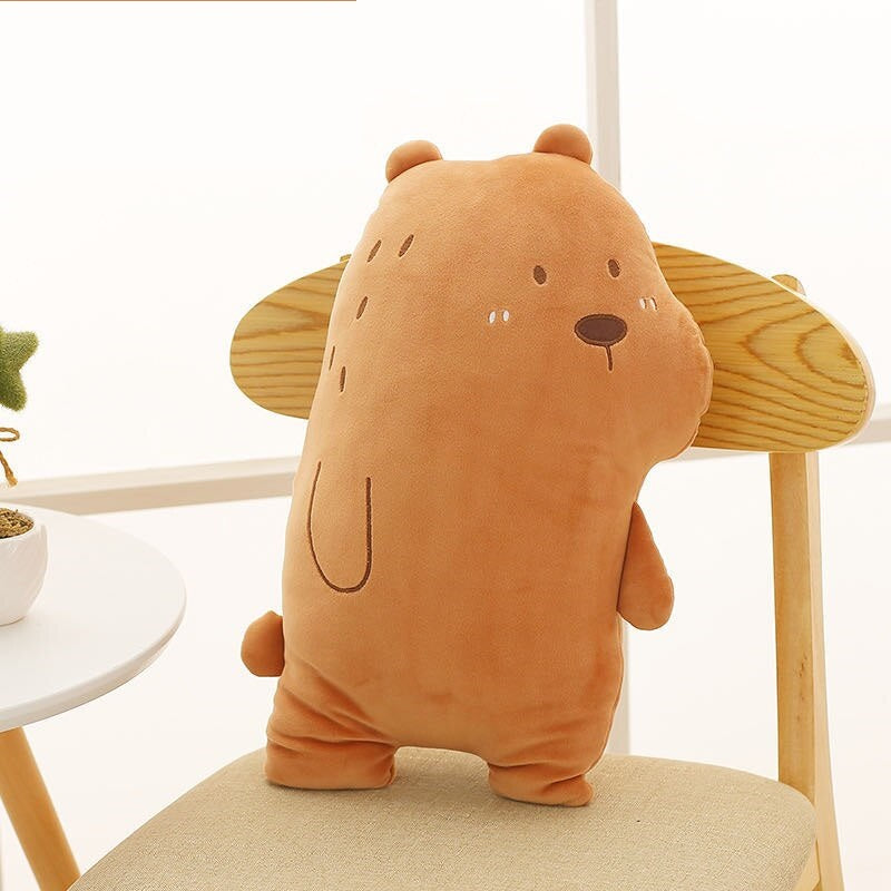 A stuffed bear sitting on a chair next to a plant.