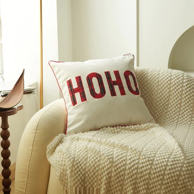 A chair with a pillow displaying the word "hoh" on it.