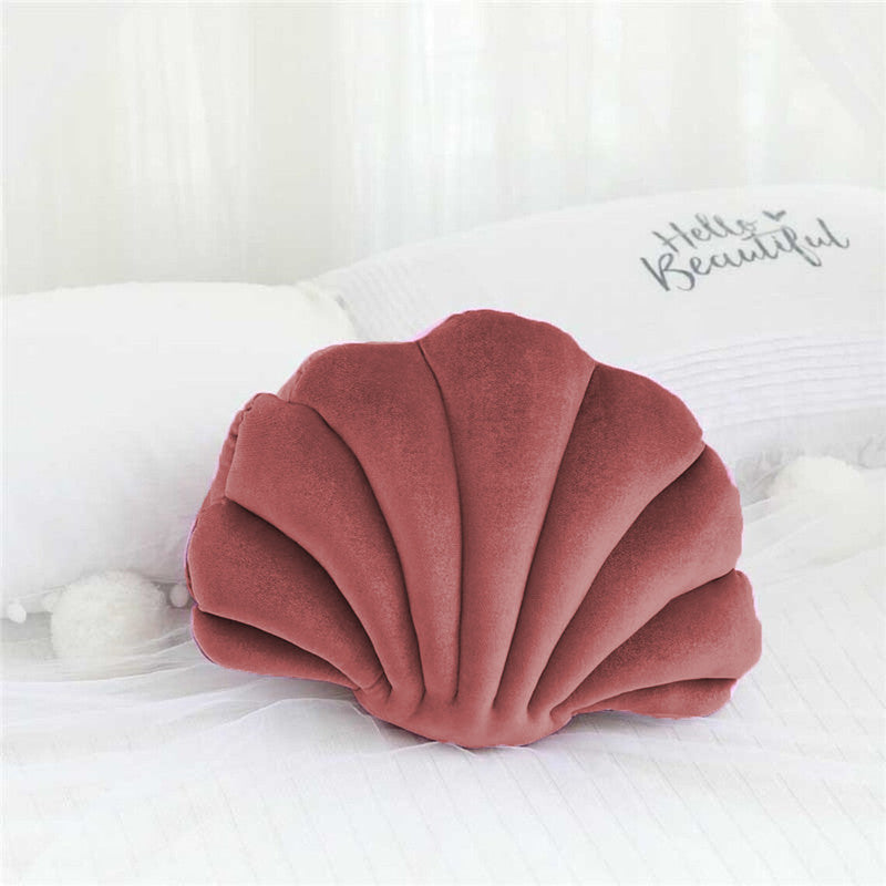  pillow with a shell shape, adding a touch of elegance and comfort to any space.