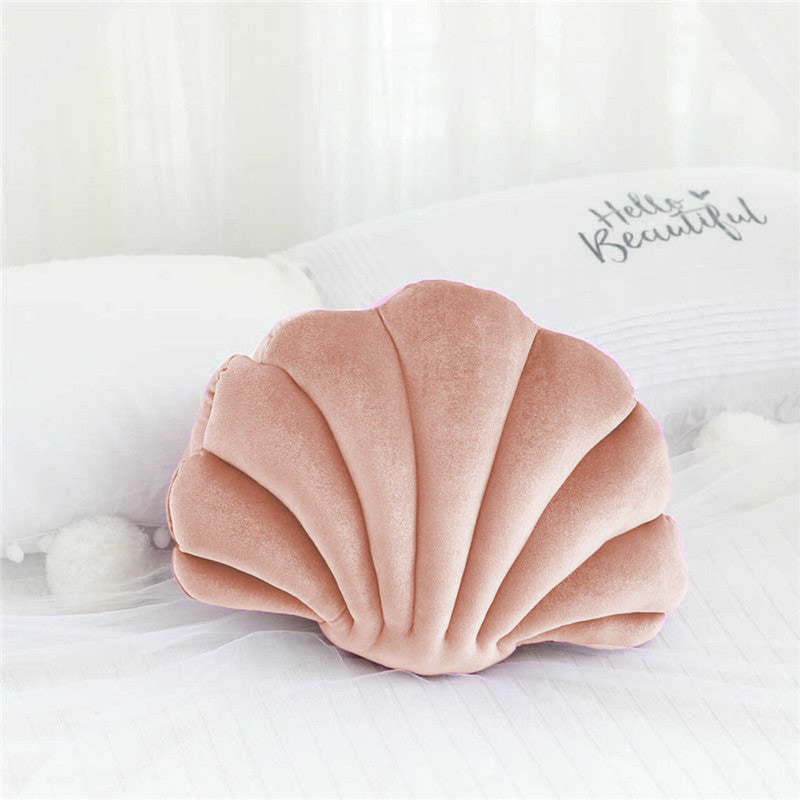  pillow with a shell shape, adding a touch of elegance and comfort to any space.